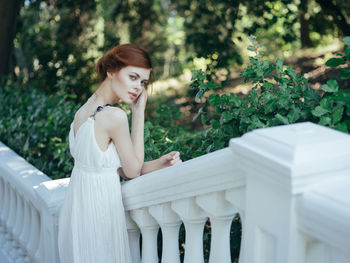 Portrait of woman against white plants