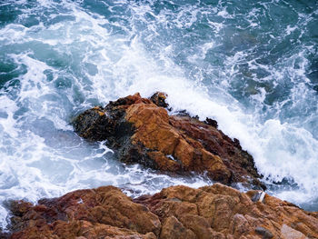 Scenic view of waves in sea against sky