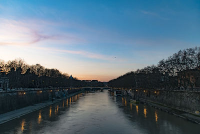 Scenic view of river against sky at sunset