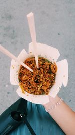 Directly above shot of woman holding food