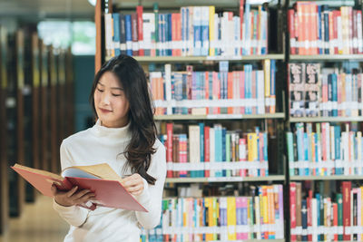 Full length of woman reading book