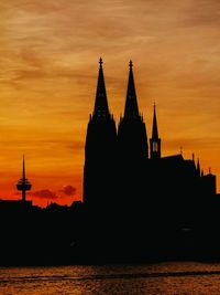 Silhouette of clock tower at sunset