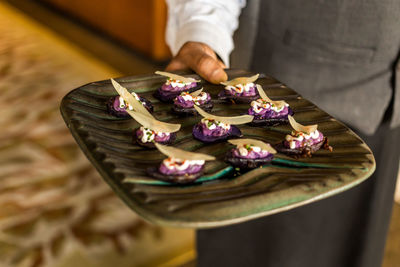 Midsection of chef holding food plate