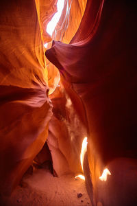 Midsection of woman holding illuminated string lights