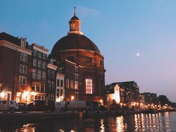 View of illuminated buildings at waterfront