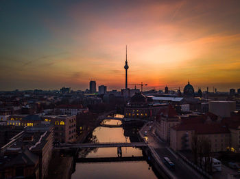 High angle view of buildings in city during sunset