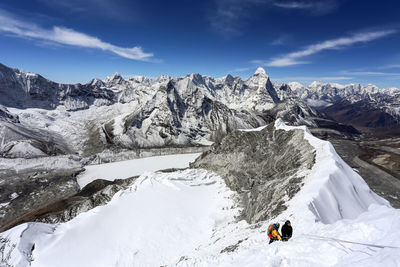 Tourists on snow covered landscape