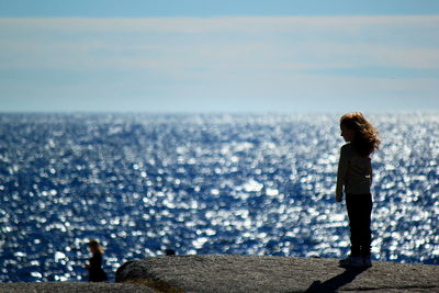 Rear view of man standing on beach