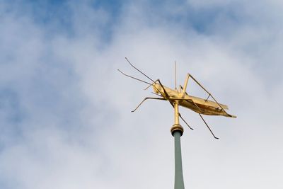 Low angle view of communications tower against sky