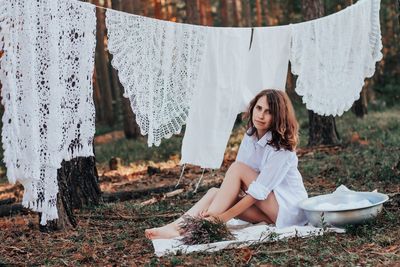 Young woman sitting on land