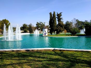 View of swimming pool by lake against sky