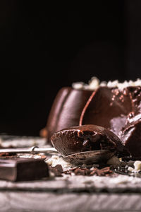 Close-up of chocolate on table against black background