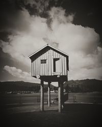 Built structure on field against sky