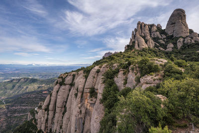 Rock formations on landscape against sky