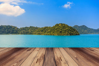 Scenic view of swimming pool by lake against sky