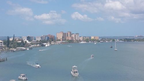 Boats in harbor with cityscape in background