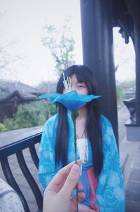 Girl holding ice cream cone during autumn