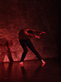 Man dancing in darkroom