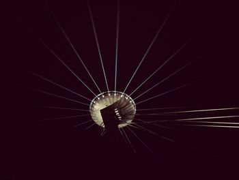 Low angle view of illuminated lights against sky at night