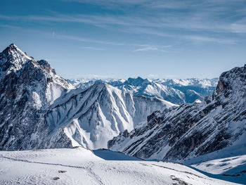 Scenic view of snowcapped mountains against sky