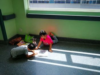 Friends drawing on floor at home