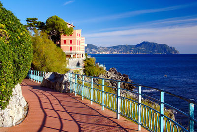 Railing on promenade against sky