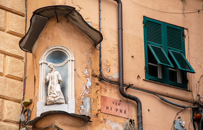 Low angle view of statue against building