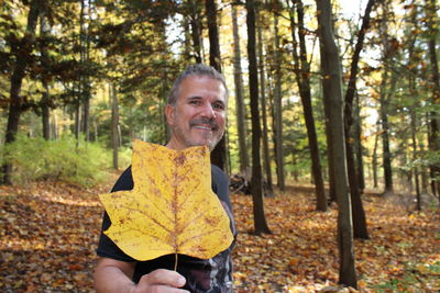 Portrait of smiling young man in forest