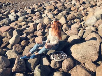 High angle view of woman sitting on rocks