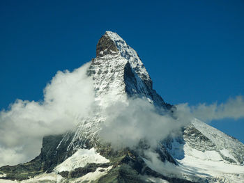 Aerial view of snowcapped mountains against sky