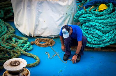 Man with rope on boat