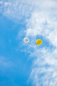 Low angle view of balloons against sky