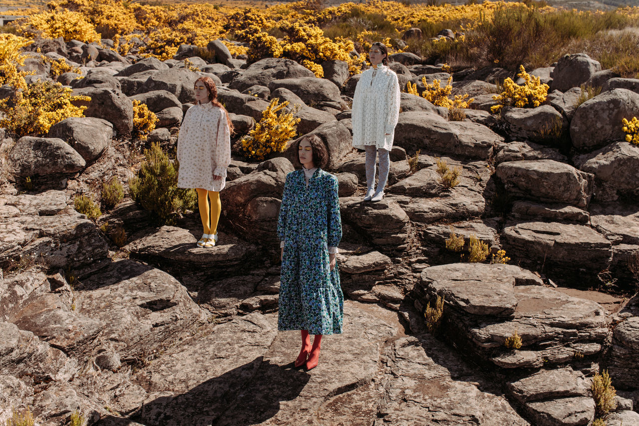 rock, rock - object, solid, real people, day, nature, rear view, women, clothing, leisure activity, full length, people, outdoors, lifestyles, standing, sunlight, adult, rock formation, autumn, warm clothing, hairstyle