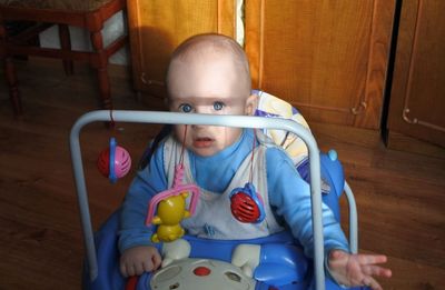 Portrait of cute baby boy on stroller