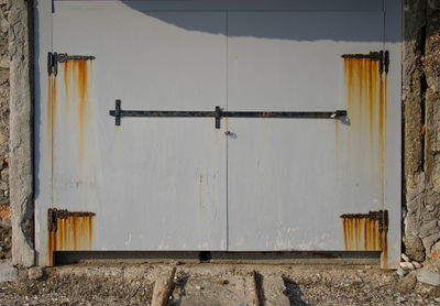 Close-up of closed rusty door of boat shed