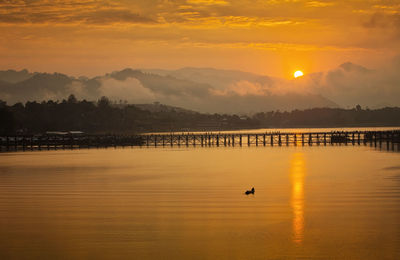 Golden morning light. mon bridge is the long wooden bridge. mon village, sangkhla buri, kanchanaburi