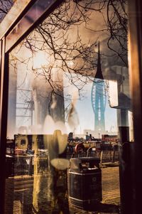 Reflection of people on glass window in restaurant