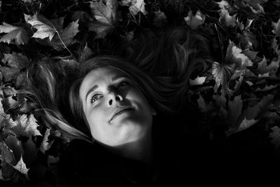 High angle view of woman lying on plants outdoors