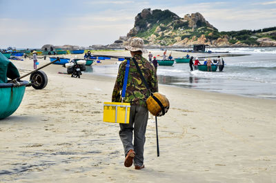 People on beach against sky