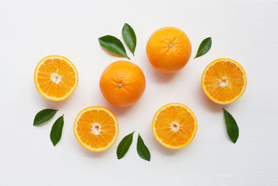 High angle view of orange fruit on white background