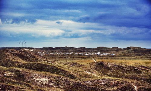 Scenic view of landscape against cloudy sky