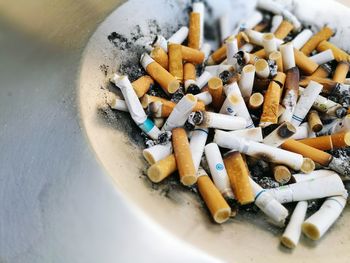 Close-up of cigarette butts in ashtray