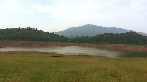 Scenic view of lake and mountains against sky