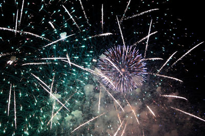 Low angle view of firework display at night