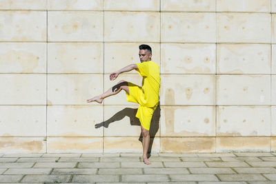 Full length of young man on wall