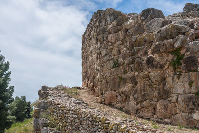 View of stone wall against cloudy sky