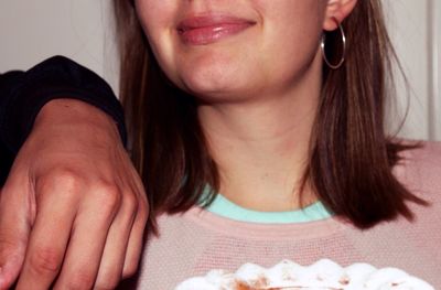 Close-up of young woman eating food