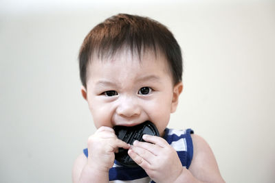 Portrait of cute baby girl holding white background