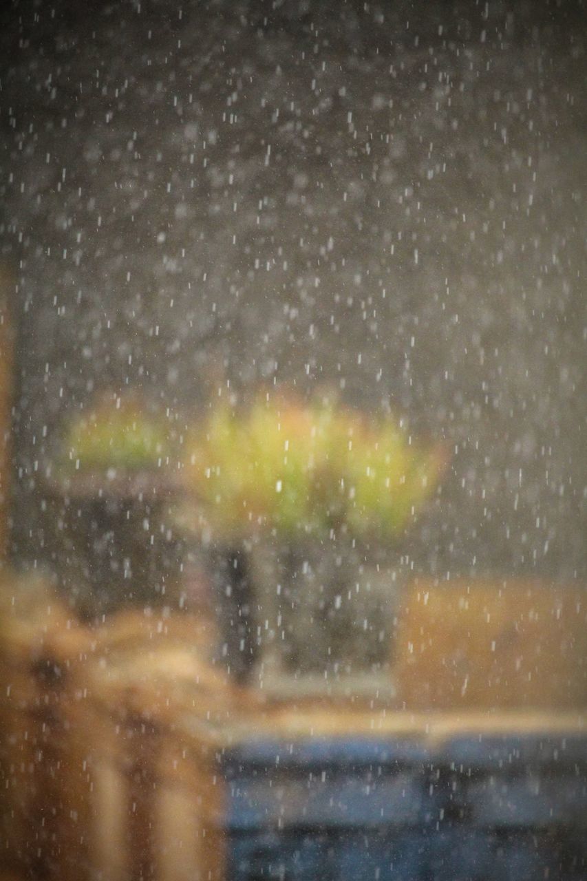 VIEW OF WET WINDOW AT NIGHT DURING RAINY SEASON