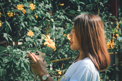 Portrait of woman holding flowers